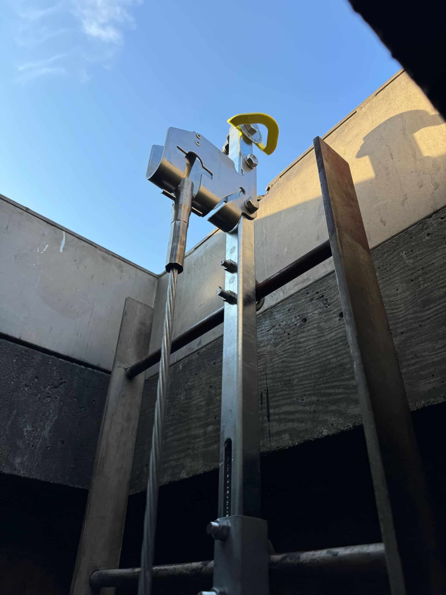 custom fabricated and engineered ladder anchor by open roof hatch