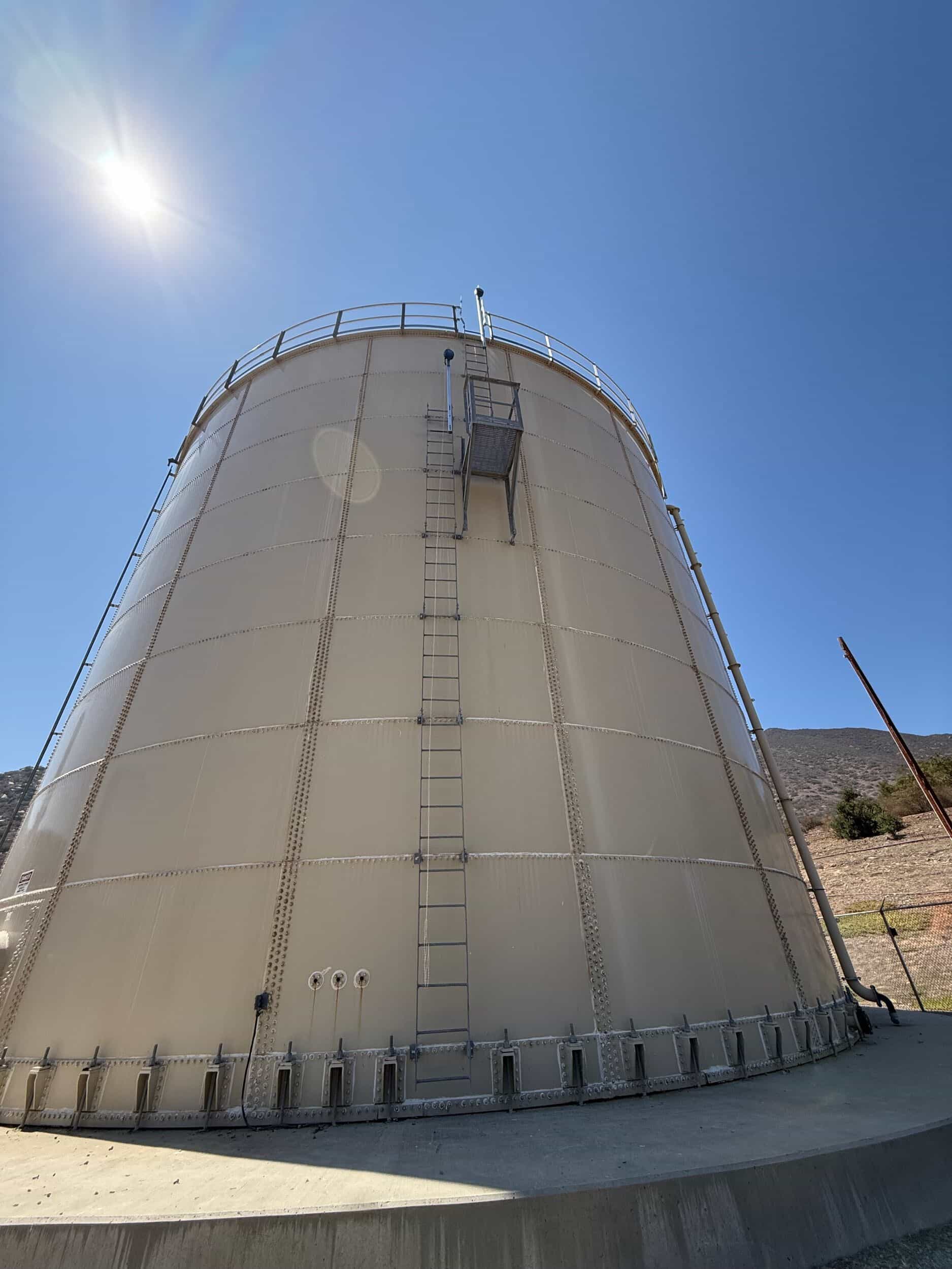 Fixed access ladder and guardrail platform on large storage tank