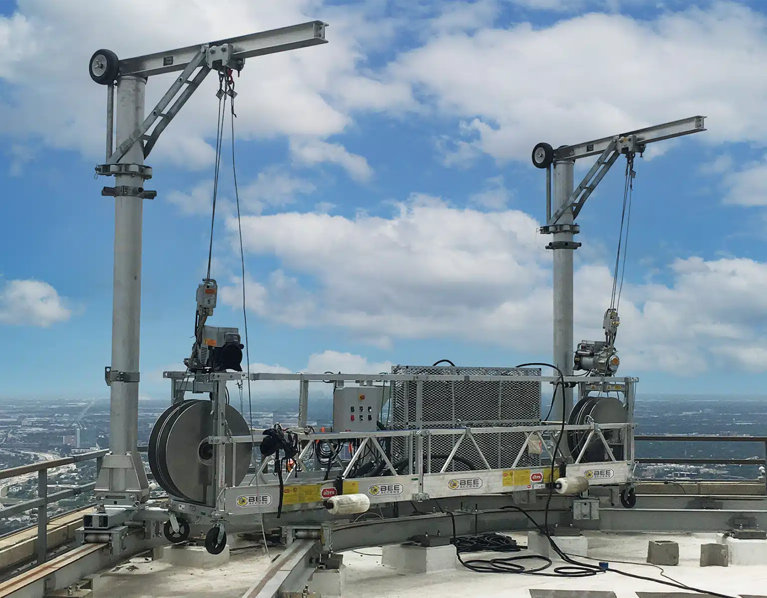 Facade access system with davit arms and suspended platform for exterior building maintenance