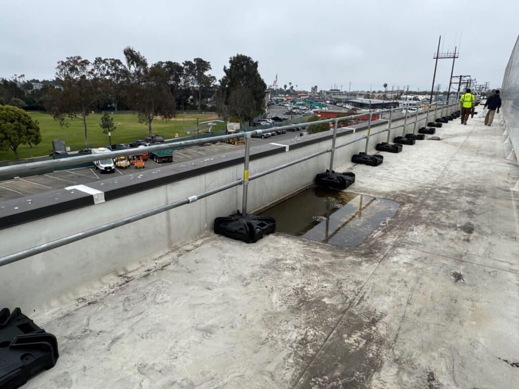 cal osha compliant non penetrating guardrail on roof next to drain